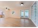 Open living room area features a view of the kitchen and backyard through glass doors at 735 Baltimore Dr, Orlando, FL 32810