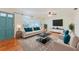 Bright living room featuring hardwood floors, large windows, and stylish contemporary furnishings at 735 Baltimore Dr, Orlando, FL 32810