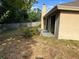 Shot of back exterior and lawn featuring sliding doors and lush green foliage at 840 Lake Jackson Cir, Apopka, FL 32703