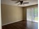 Bedroom featuring hardwood floors and sliding doors with vertical blinds for natural light at 840 Lake Jackson Cir, Apopka, FL 32703