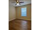Cozy bedroom featuring a ceiling fan, wood-look floors and a window at 840 Lake Jackson Cir, Apopka, FL 32703