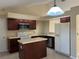 Kitchen with dark wood cabinets, kitchen island, and stainless steel appliances at 840 Lake Jackson Cir, Apopka, FL 32703
