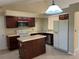 Kitchen featuring dark wood cabinets, a kitchen island, and stainless steel appliances at 840 Lake Jackson Cir, Apopka, FL 32703