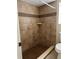 Bathroom with a walk-in shower featuring updated tile and a built-in shelf at 840 Lake Jackson Cir, Apopka, FL 32703