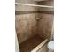 Bathroom with a walk-in shower featuring updated tile and a built-in shelf at 840 Lake Jackson Cir, Apopka, FL 32703