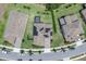 Aerial view of a well-maintained property with a dark roof, solar panels, and manicured lawns at 8768 Sonoma Coast Dr, Winter Garden, FL 34787