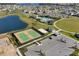 Community aerial view featuring tennis courts, beach volleyball, clubhouse, pool and beautiful Florida landscaping at 8768 Sonoma Coast Dr, Winter Garden, FL 34787
