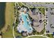 Stunning aerial view of the community clubhouse and pool area, surrounded by lush landscaping and parking at 8768 Sonoma Coast Dr, Winter Garden, FL 34787