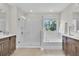 A bright bathroom featuring a tiled walk-in shower, a soaking tub, and double vanity sinks at 8768 Sonoma Coast Dr, Winter Garden, FL 34787