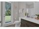 Bright bathroom features a glass door, wooden floors, and a large window with a view of the outdoors at 8768 Sonoma Coast Dr, Winter Garden, FL 34787