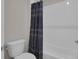 Clean bathroom with modern fixtures and a white tiled shower with a patterned curtain at 8768 Sonoma Coast Dr, Winter Garden, FL 34787