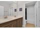 Elegant bathroom with double sinks, a large mirror, and a separate toilet and shower area at 8768 Sonoma Coast Dr, Winter Garden, FL 34787