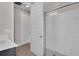 Modern bathroom featuring a white shower with glass door, and white cabinets and drawers at 8768 Sonoma Coast Dr, Winter Garden, FL 34787