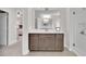 A bathroom with double vanity and sink, modern cabinets, large mirror, and a shower with glass door at 8768 Sonoma Coast Dr, Winter Garden, FL 34787