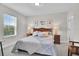 Bedroom with a plush bed and natural lighting from the window, creating a calming atmosphere at 8768 Sonoma Coast Dr, Winter Garden, FL 34787