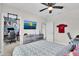 Cozy bedroom with stylish decor, including a TV and a sporty jersey on the wall at 8768 Sonoma Coast Dr, Winter Garden, FL 34787