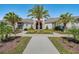 Beautiful Waterleigh clubhouse entrance boasting stone accents, lush landscaping, and a welcoming walkway at 8768 Sonoma Coast Dr, Winter Garden, FL 34787