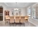 Bright dining room features a chandelier, tile flooring, and three decorative mirrors at 8768 Sonoma Coast Dr, Winter Garden, FL 34787