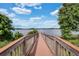 Scenic view of a wooden dock leading to a tranquil lake surrounded by lush greenery at 8768 Sonoma Coast Dr, Winter Garden, FL 34787