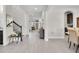 Bright and spacious foyer with hardwood floors, an open staircase, and views into the dining area at 8768 Sonoma Coast Dr, Winter Garden, FL 34787