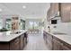 Open concept kitchen features a spacious island, modern appliances, and a seamless flow to dining at 8768 Sonoma Coast Dr, Winter Garden, FL 34787