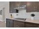 Well-equipped kitchen with modern appliances, granite countertops, and a stylish tile backsplash at 8768 Sonoma Coast Dr, Winter Garden, FL 34787