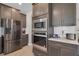 Gourmet kitchen features stainless steel appliances, sleek countertops, and custom cabinetry for storage at 8768 Sonoma Coast Dr, Winter Garden, FL 34787