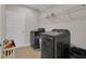 Functional laundry room with modern appliances and a wire shelf for storage at 8768 Sonoma Coast Dr, Winter Garden, FL 34787
