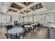 Clubhouse lounge featuring coffered ceiling, fireplace, television, and comfortable seating at 8768 Sonoma Coast Dr, Winter Garden, FL 34787