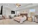 Bright main bedroom featuring tray ceiling, carpet flooring, a king bed and two dressers for ample storage at 8768 Sonoma Coast Dr, Winter Garden, FL 34787