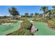Well-manicured mini golf course surrounded by lush landscaping and picturesque scenery at 8768 Sonoma Coast Dr, Winter Garden, FL 34787