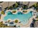 Aerial view of community pool featuring a lagoon design, ample lounge chairs and lush tropical landscaping at 8768 Sonoma Coast Dr, Winter Garden, FL 34787