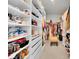 Spacious walk-in closet with built-in shelving, drawers, and hanging rods for organized storage at 8768 Sonoma Coast Dr, Winter Garden, FL 34787