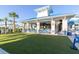 Outdoor bar area with covered seating, modern design, and a lush green lawn at 880 Paradise Dr, Davenport, FL 33897