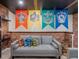Basement with brick wall and couch displaying house banners and Harry Potter themed pillows at 880 Paradise Dr, Davenport, FL 33897
