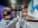 Finished basement area with brick accents, house banners, a bookshelf mural and comfortable seating at 880 Paradise Dr, Davenport, FL 33897