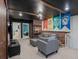 Finished basement area with brick accents, a house banner display and comfortable seating at 880 Paradise Dr, Davenport, FL 33897