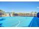 Enjoy the outdoors with this dedicated community basketball court with palm trees and blue sky at 880 Paradise Dr, Davenport, FL 33897