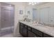 Bright bathroom with dual sinks, granite countertop, shower, and neutral walls at 880 Paradise Dr, Davenport, FL 33897