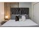 Beautiful bedroom featuring a large bed with upholstered headboard and stylish bedside table at 880 Paradise Dr, Davenport, FL 33897