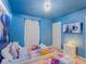 This cozy bedroom offers twin beds, Frozen-themed decor, and a relaxing atmosphere at 880 Paradise Dr, Davenport, FL 33897