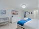 Bedroom with television, crib, and adjacent access to walk-in closet at 880 Paradise Dr, Davenport, FL 33897