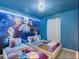 This delightful bedroom features themed decor, twin beds, and custom wall art at 880 Paradise Dr, Davenport, FL 33897