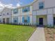 Well-maintained two-story home with tidy front lawn and walkway leading to a covered entryway at 880 Paradise Dr, Davenport, FL 33897