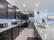 Modern kitchen featuring dark cabinetry and stainless steel appliances at 880 Paradise Dr, Davenport, FL 33897