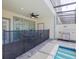 Relaxing outdoor patio featuring a dining table, ceiling fan, and access to a private pool at 880 Paradise Dr, Davenport, FL 33897