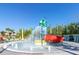 Fun splash pad area with colorful slides and playful water features for Gathering entertainment at 880 Paradise Dr, Davenport, FL 33897