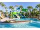 Fun water park area with colorful slides and a refreshing pool, surrounded by palm trees at 880 Paradise Dr, Davenport, FL 33897