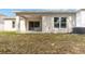 Backyard with an extended covered patio and lawn at 928 Avenal Ln, Davenport, FL 33837