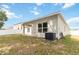 Backyard featuring covered patio, lawn, AC unit, and privacy fence at 928 Avenal Ln, Davenport, FL 33837